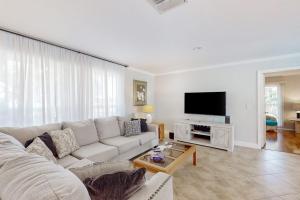 a living room with a couch and a flat screen tv at Seaside Serenity in Punta Gorda