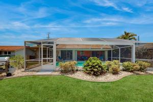 a house with a pool in the yard at Seaside Serenity in Punta Gorda