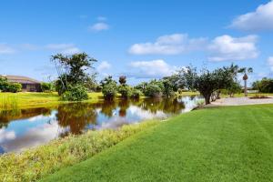 a river in a park with trees and grass at Waterway Whispers in Rotunda-West