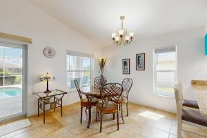 a dining room with a table and chairs at Waterway Whispers in Rotunda-West