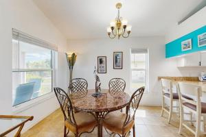 a dining room with a table and chairs at Waterway Whispers in Rotunda-West +16 photos
