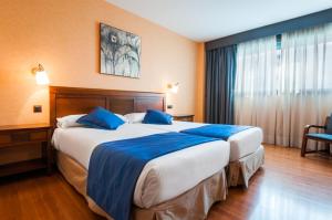 Łóżko lub łóżka w pokoju w obiekcie Hotel Las Provincias