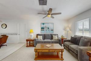 a living room with a couch and a ceiling fan at Lil Blue in Punta Gorda