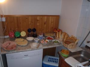 a kitchen counter with a bunch of food on it at Penzion Mikeš in Pec pod Sněžkou +20 photos