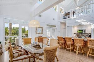 a kitchen and dining room with a table and chairs at Bocilla Breeze in Bokeelia +40 photos