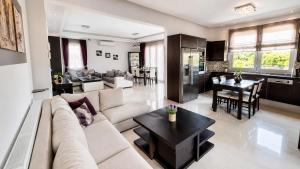 a living room with a couch and a table at Rhodian Villa in Kremasti