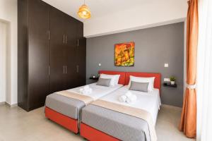 a bedroom with two beds and a red headboard at Rhodian Villa in Kremasti +10 photos