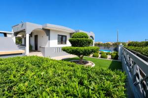 a view of a house with a tree on a balcony at Rhodian Villa in Kremasti