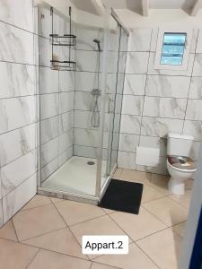 a shower stall in a bathroom with a toilet at Ti Kaz en Nou' in Pointe-Noire +28 photos
