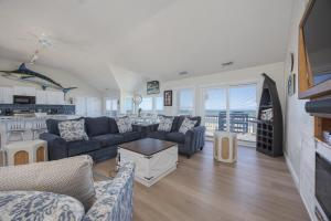 a living room with couches and a kitchen at 7674 - The Sweet Escape in Avon