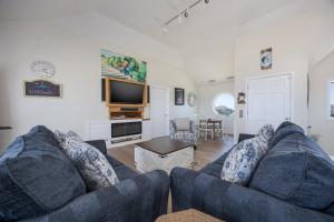 a living room with a blue couch and a tv at 7674 - The Sweet Escape in Avon +46 photos