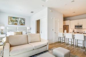 a living room with a couch and a kitchen at SoCe Flats 209 in Naples