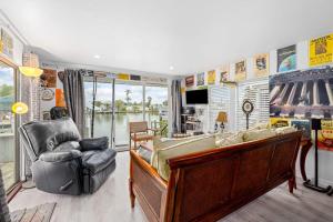 a living room with a couch and a chair at Sunset Escape in Marco Island