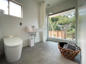 a bathroom with a toilet and a window at Beppu TOJIHAUS 001 2min walk to Shibaseki Onsen in Beppu +63 photos