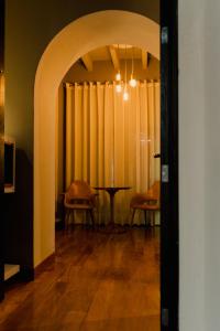 an archway with a table and chairs in a room at Dos Casas Hotel & Spa in San Miguel de Allende