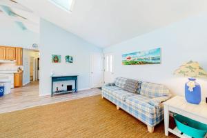 a living room with a couch and a fireplace at The Canal -- 337 Sandpiper in Bethany Beach