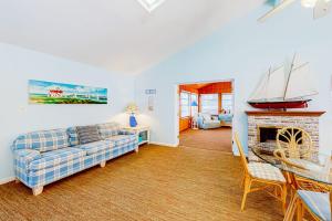 a living room with a couch and a fireplace at The Canal -- 337 Sandpiper in Bethany Beach