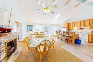 a kitchen and living room with a table and chairs at The Canal -- 337 Sandpiper in Bethany Beach