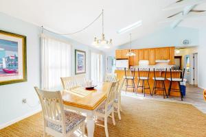 a dining room and kitchen with a table and chairs at The Canal -- 337 Sandpiper in Bethany Beach +17 photos