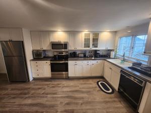 a kitchen with white cabinets and black appliances at Single Level Spacious Home - A JBMB Property in Middletown