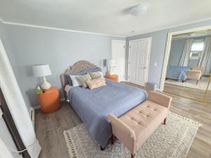 a bedroom with a bed and a chair in it at Single Level Spacious Home - A JBMB Property in Middletown