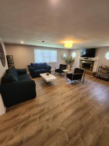 a living room with a couch and chairs and a fireplace at Single Level Spacious Home - A JBMB Property in Middletown