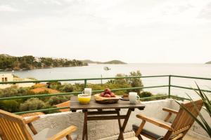a table with a bowl of fruit on a balcony at Nimfi Hotel, Skiathos in Megali Ammos +46 photos