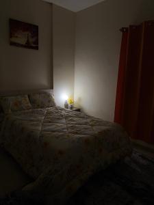 a bedroom with a bed with a light on it at Abdulla al Shaiba in Jazīrat al Ḩibāb