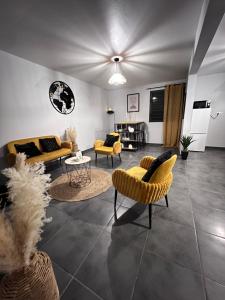 a living room with couches and chairs at Golden palm in Rivière-Pilote
