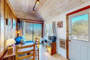a tiny house with a living room and a door at North Truro Bayside Gem in Truro