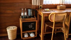 a room with a table and a desk with a chair at The Woods Uluwatu in Uluwatu
