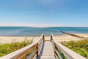 a stairway to the beach with the ocean in the background at Seaside Sanctuary in Harwich