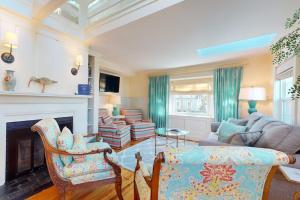 a living room with a couch and a fireplace at Seaside Sanctuary in Harwich