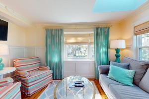 a living room with a couch and a glass table at Seaside Sanctuary in Harwich +23 photos