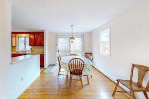 a kitchen and dining room with a table and chairs at Corner Cottage in Chatham
