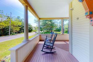 a rocking chair on the front porch of a house at Old Mansard in West Dennis