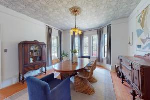 a dining room with a wooden table and chairs at Old Mansard in West Dennis +39 photos