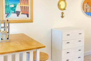 a white dresser and a table in a room at National Seashore Studio in Truro