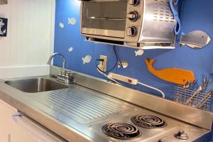 a kitchen with a sink and a microwave at National Seashore Studio in Truro +11 photos