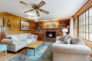 a living room with two couches and a fireplace at Herring Brook in Eastham