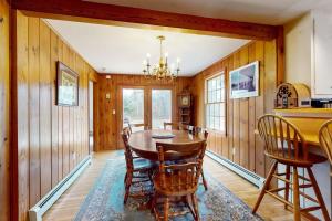 a dining room with a table and chairs at Herring Brook in Eastham