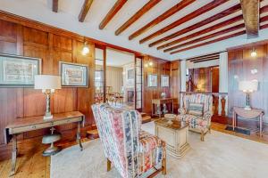 a living room with wooden walls and a table and chairs at Capeview Estate in Bourne