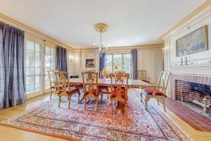 a dining room with a table and chairs and a fireplace at Capeview Estate in Bourne +42 photos