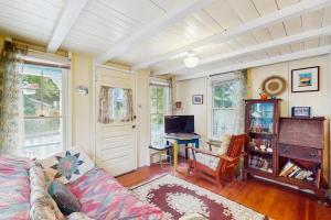 a living room with a couch and a desk at TumbleINN in Oak Bluffs