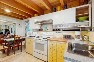 a kitchen with a sink and a stove top oven at TumbleINN in Oak Bluffs +11 photos
