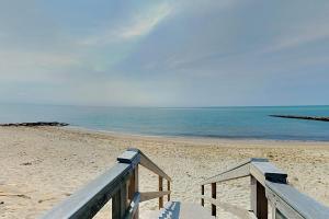 a wooden staircase leading to the beach at Summer Cape Escape in Dennis Port