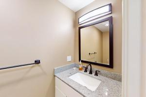 a bathroom with a sink and a mirror at Summer Cape Escape in Dennis Port