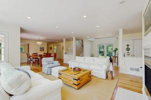 a living room with white couches and a table at Family Getaway in Oak Bluffs