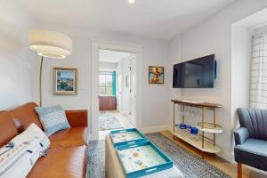 a living room with a couch and a tv at Fun in the Sun in Provincetown