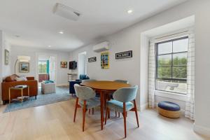 a living room with a wooden table and chairs at Fun in the Sun in Provincetown